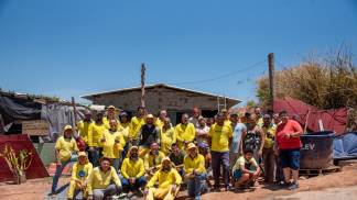 Membros da Pastoral da Moradia em frente  a casa