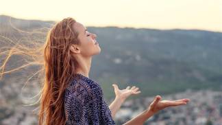 mulher com braços abertos em oração