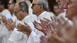 bispos com as mãos em oração e adoração durante missa na 62ª assembleia da cnbb