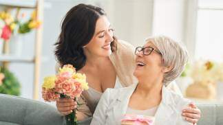 Filha dando flores a mãe pelo Dia das mães