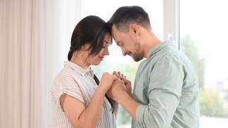 casal rezando de mãos dadas