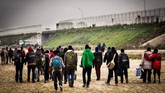 migrantes caminhando em grupo